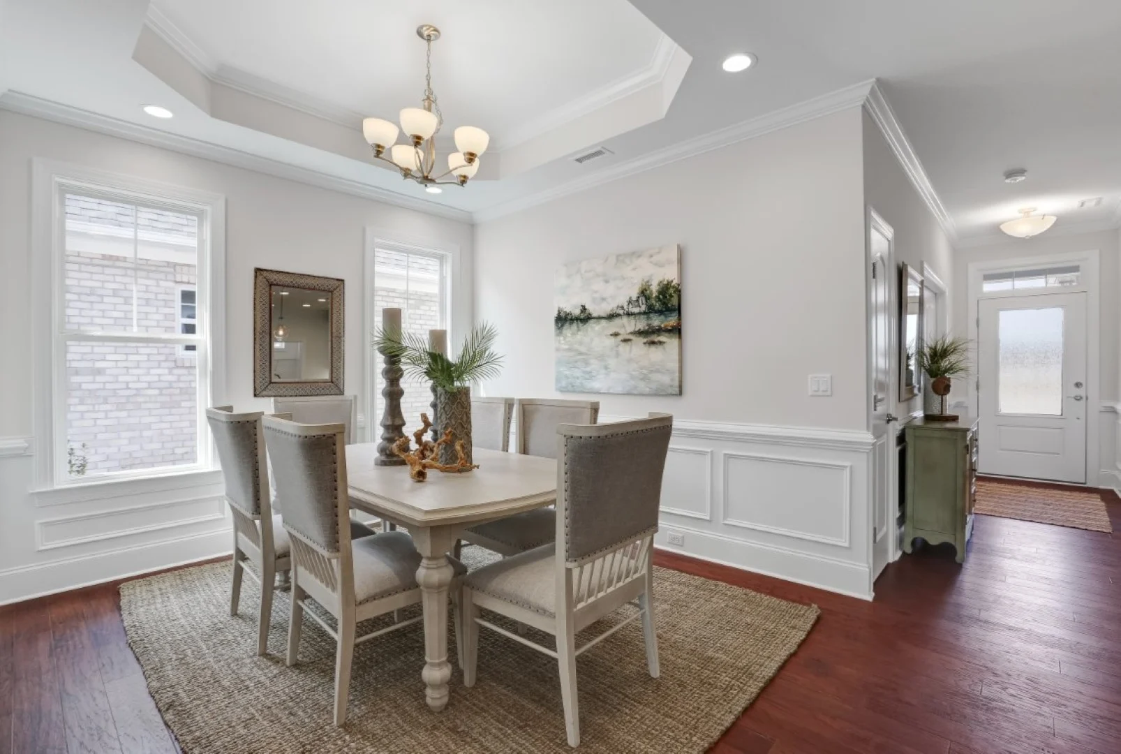 gallery-kitchen (54) Elegant dining area with stylish chandelier, neutral tones, art, and large windows, showcasing home builder craftsmanship.